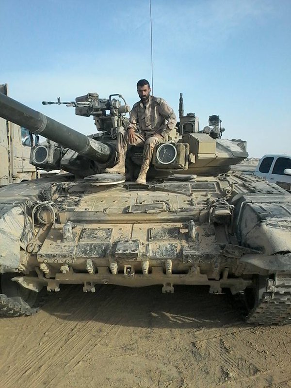 Syrian soldier posing with a Russian military T-90A, location is likely to be Eastern Homs. One shtora is cracked  