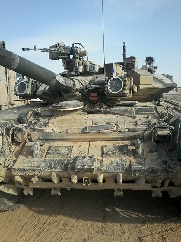 Syrian soldier posing with a Russian military T-90A, location is likely to be Eastern Homs. One shtora is cracked  