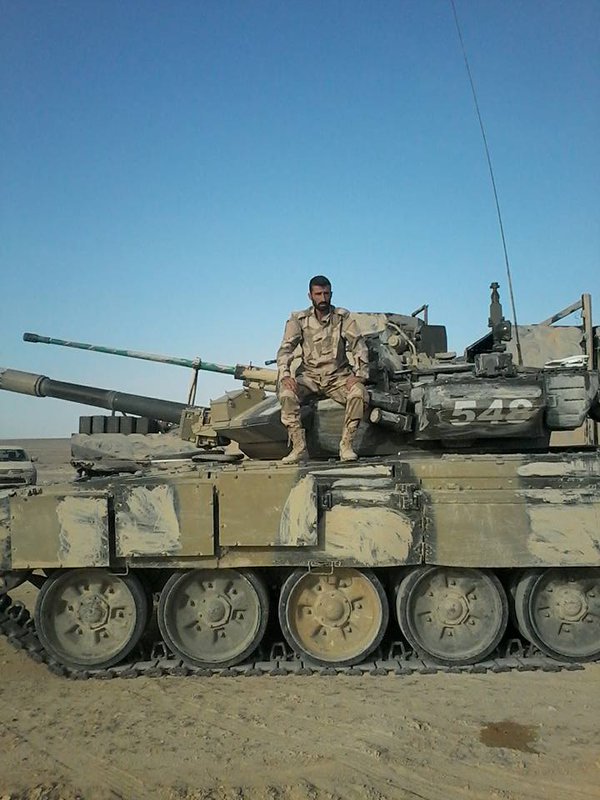 Syrian soldier posing with a Russian military T-90A, location is likely to be Eastern Homs. One shtora is cracked  