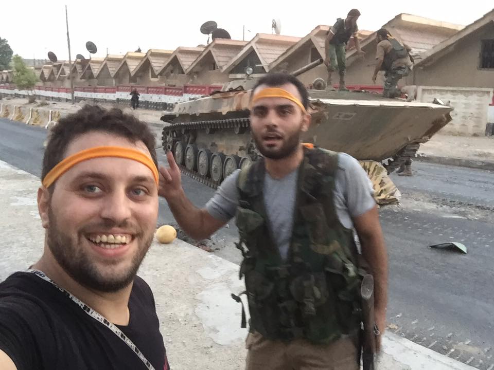 East Aleppo media activist Mahmoud Raslan in Ramouseh today. In the background is a tank captured by the rebels.  