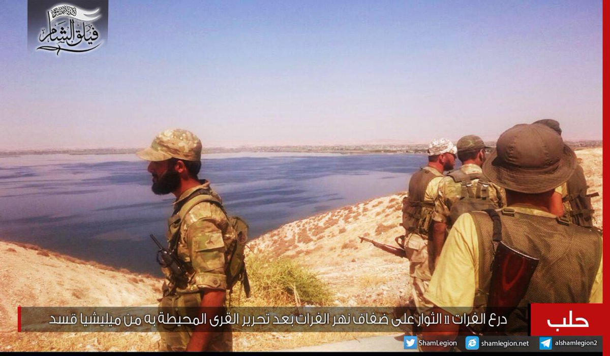 Sham Legion fighters on the shores of the Euphrates river after capturing villages in the area