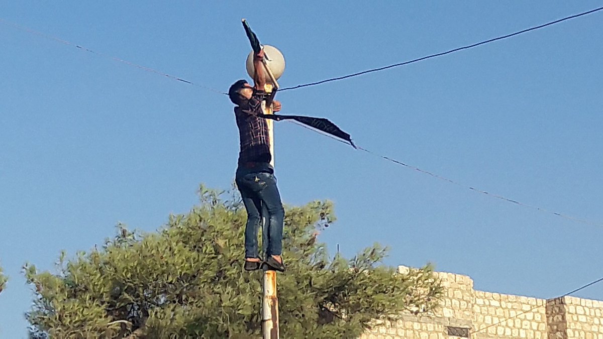 Protesters in Maarat a-Numan, Idlib, take down Jabhat a-Nusra (HTS) flags  and  chant against the group.  