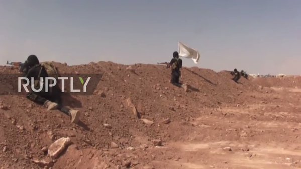 Russian media visits Iraqi Shi'a militia base in Syrian badiyah near border, shows heavy deployment including Humvees and tanks.