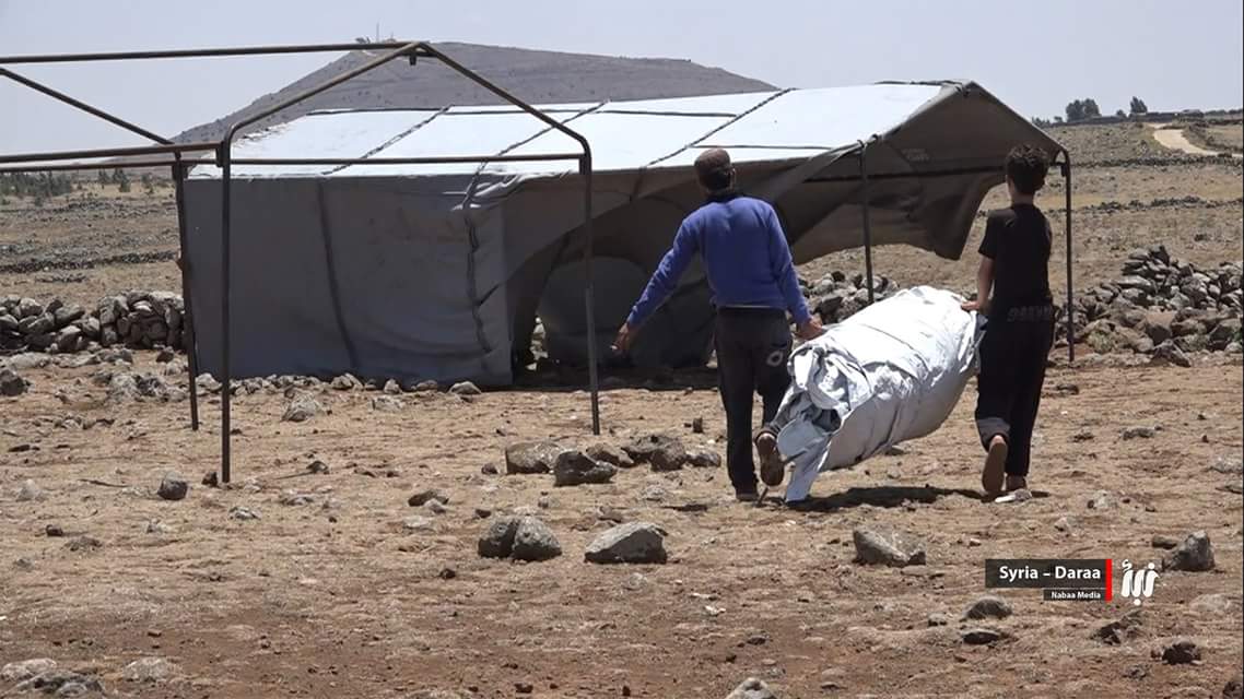 Photos: Children helping their families to build tent camps after displaced by Russian strikes on Daraa