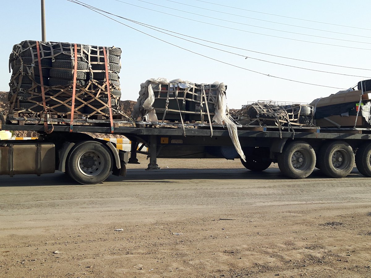 Trucks loaded with supplies/equipment from the @Coalition driving through Qamishlo city in Northern Syria  Kurdistan today, accompanied by a military vehicle for protection.   