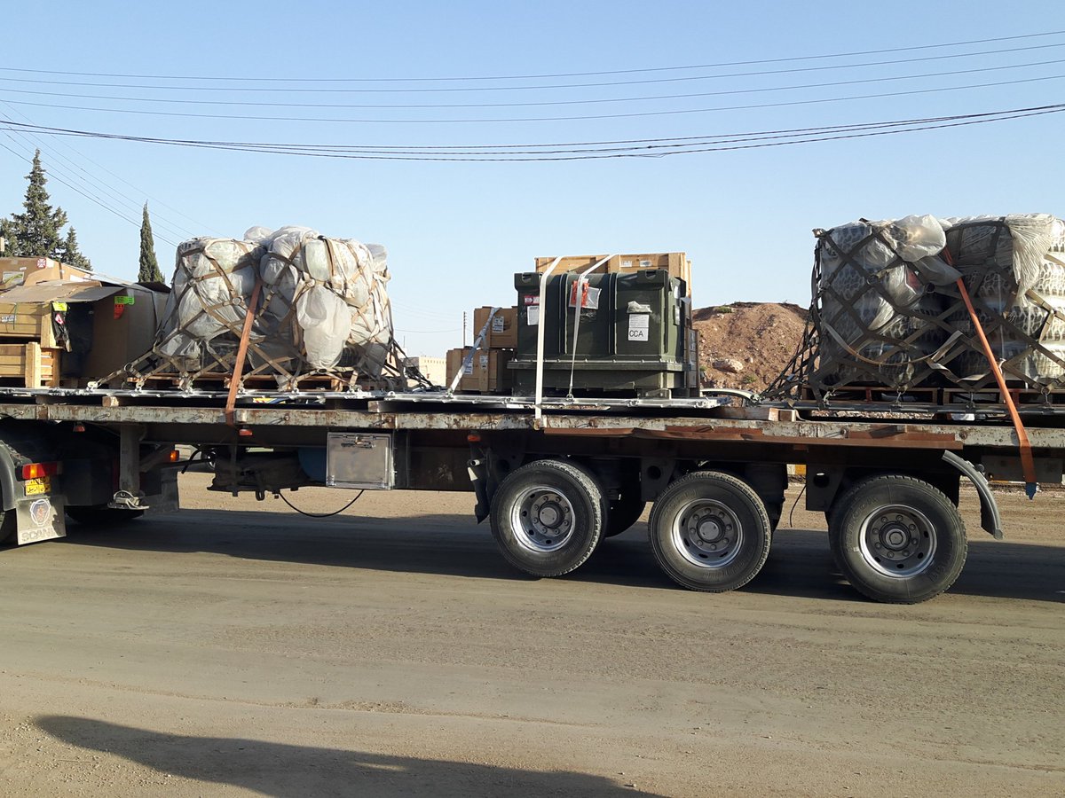 Trucks loaded with supplies/equipment from the @Coalition driving through Qamishlo city in Northern Syria  Kurdistan today, accompanied by a military vehicle for protection.   