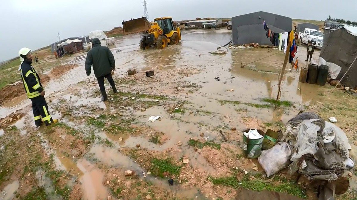 The evacuation of number of families effected by the floods and opening corridors to discharge rain water in the camp of Skin near the city of Maarat al-Nu'man south of Idlib, the work continues.   