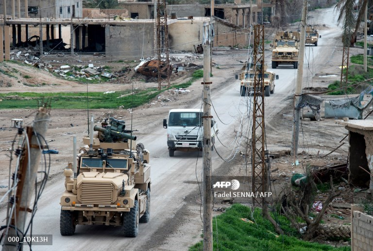 Another column, in Baguz village, of US Forces Cougar 4x4 TOW, Oshkosh and Humvees.  Photo: Fadel SENNA / AFP   