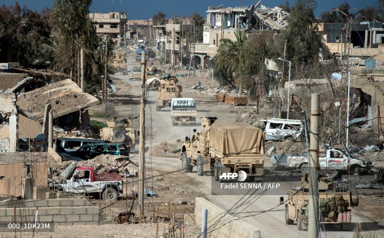 Another column, in Baguz village, of US Forces Cougar 4x4 TOW, Oshkosh and Humvees.  Photo: Fadel SENNA / AFP   