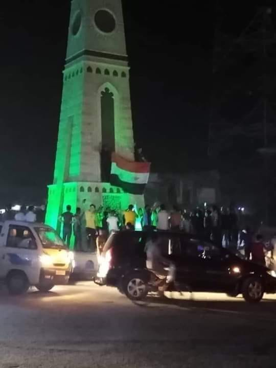 City of Raqqa: Raising the flag of the Syrian Arab Republic at the clock roundabout in downtown Raqqa