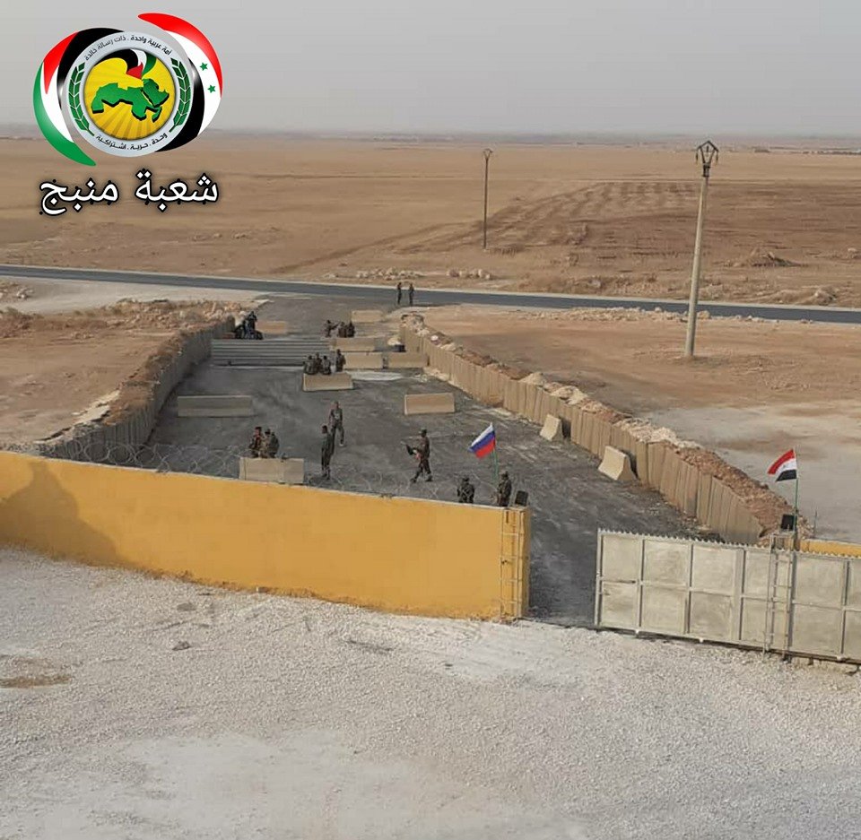 Russian and Syrian official flag at checkpoint at Dibis village on the road Ayn Issa Sarrin