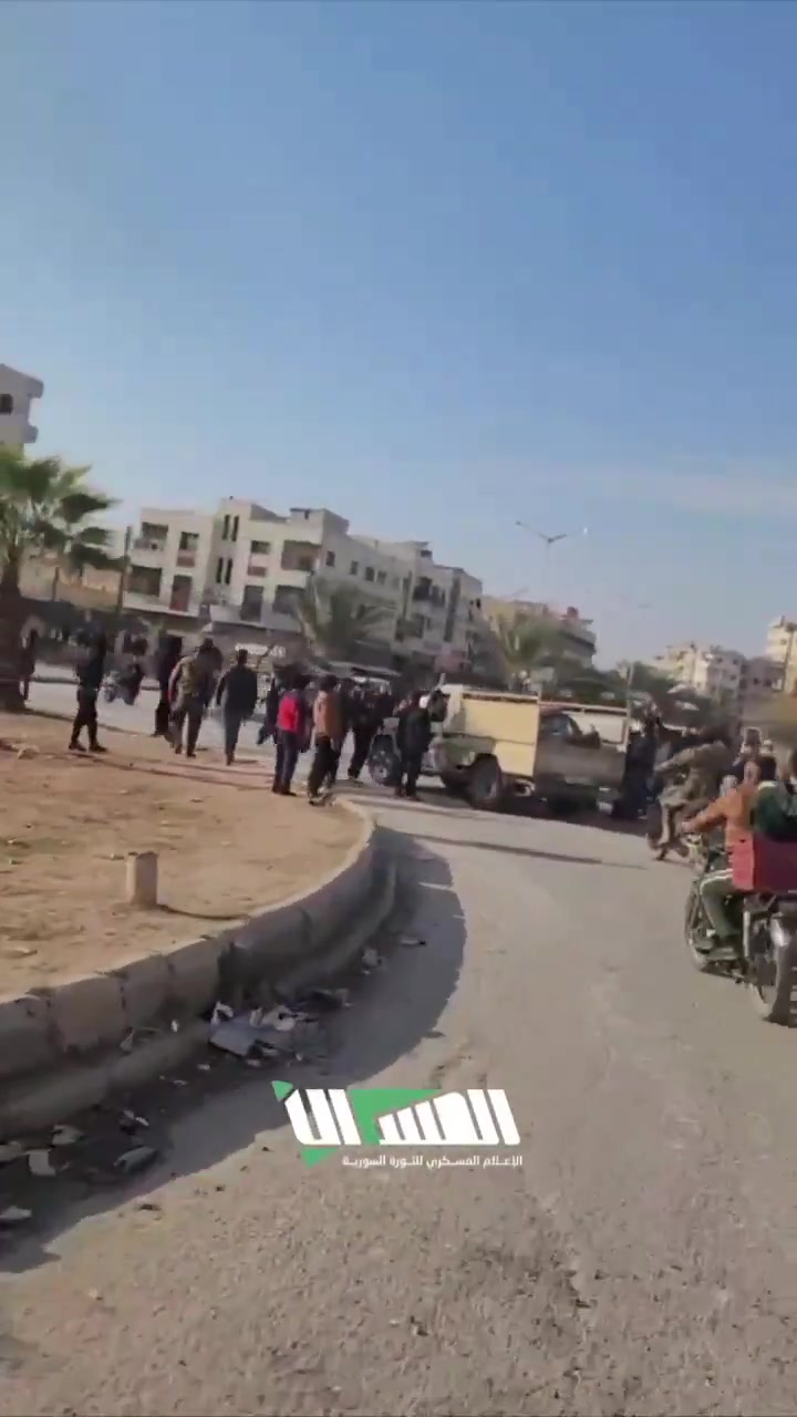 The streets of Hama following the rebel-takeover. Residents gather at intersections to greet rebel forces as they enter they city