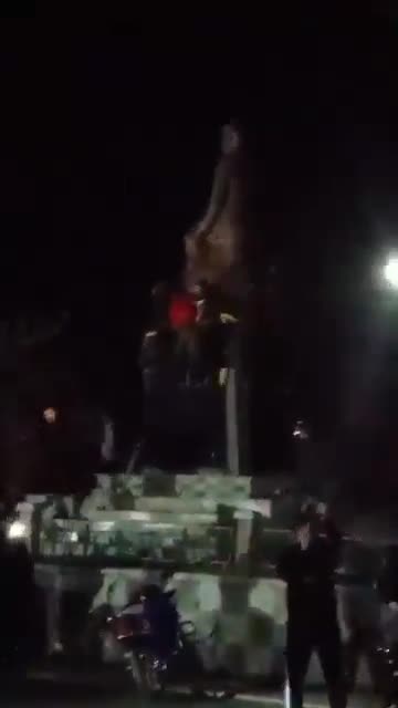 Statue of Hafez al-Assad falling again in the center of Daraa city after the rebels controlled the city