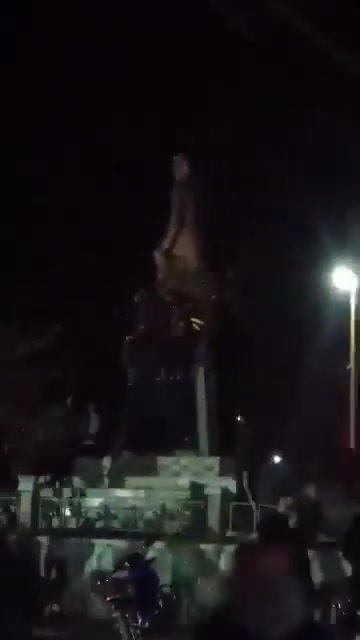 Statue of Hafez al-Assad falling again in the center of Daraa city after the rebels controlled the city