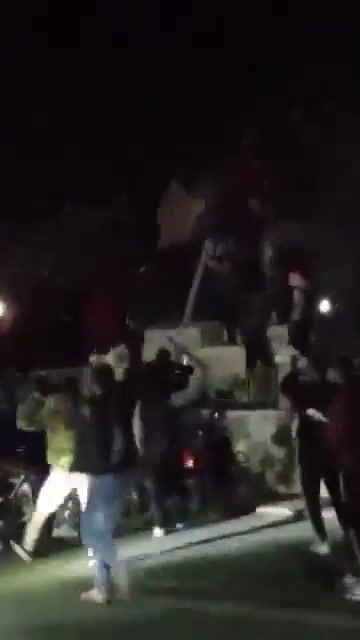 Statue of Hafez al-Assad falling again in the center of Daraa city after the rebels controlled the city