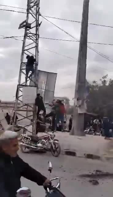 Removing images of Pro-Assad forces symbols after government forces withdraw from Darayya city in Damascus countryside