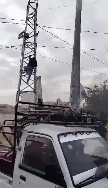 Removing images of Pro-Assad forces symbols after government forces withdraw from Darayya city in Damascus countryside