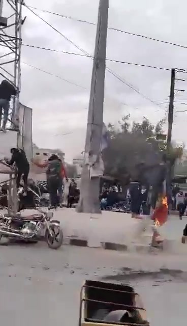 Removing images of Pro-Assad forces symbols after government forces withdraw from Darayya city in Damascus countryside