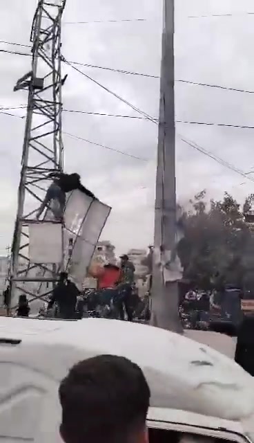 Removing images of Pro-Assad forces symbols after government forces withdraw from Darayya city in Damascus countryside