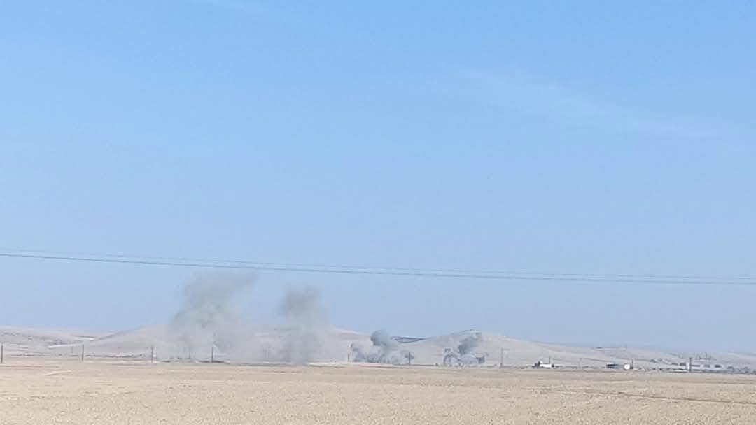 A photo shows columns of smoke rising from airstrikes near the Tishrin Dam