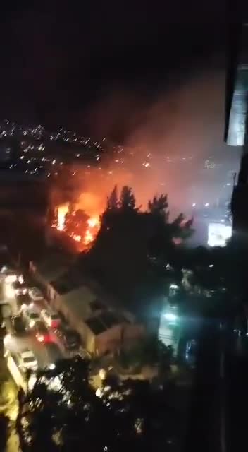 A fire broke out in trees near Al-Wahda Club in the Al-Mazraa neighborhood in central Damascus. Civil defense teams are working to extinguish the fire.