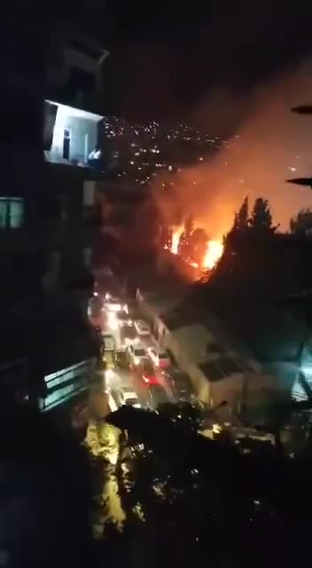 A fire broke out in trees near Al-Wahda Club in the Al-Mazraa neighborhood in central Damascus. Civil defense teams are working to extinguish the fire.
