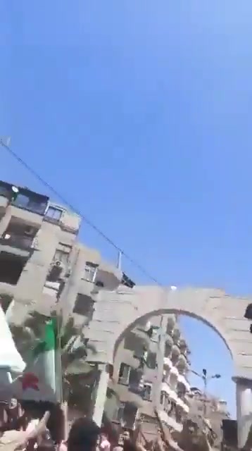 In Jarmana near Damascus, the new Syrian flag is being removed